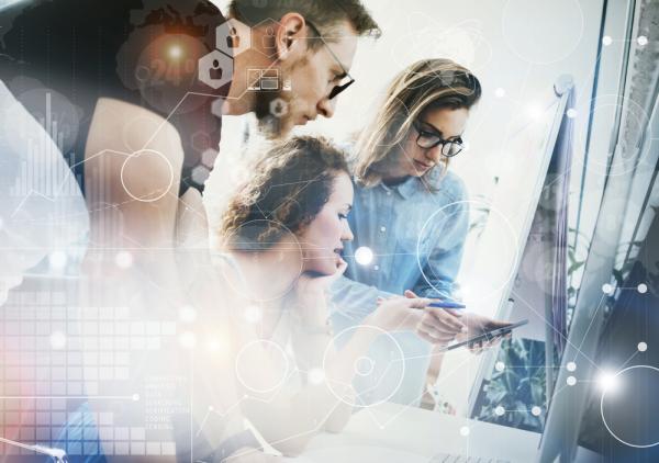 A leadership team works together to review employee performance management, with an overlay of graphics.