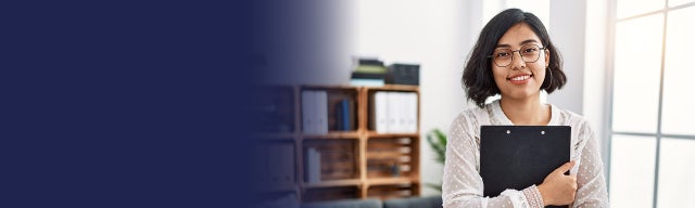 Woman holding a clipboard smiling to camera