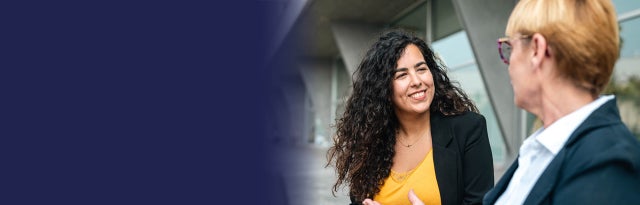 Image of two business people having a friendly conversation, representing the services offered by Keypath Education