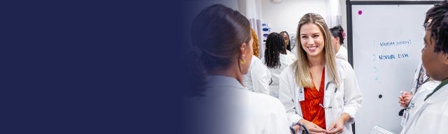 Group of nursing students standing in front of a board